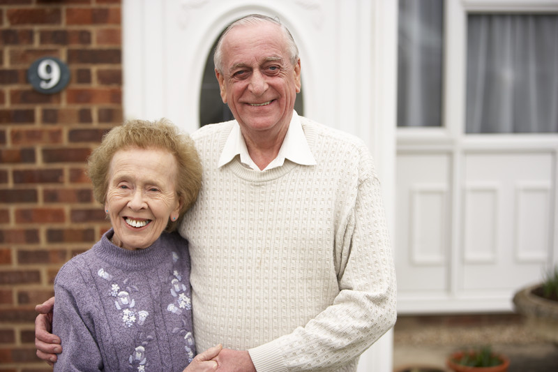 senior couple in front of their house in Orange County, CA